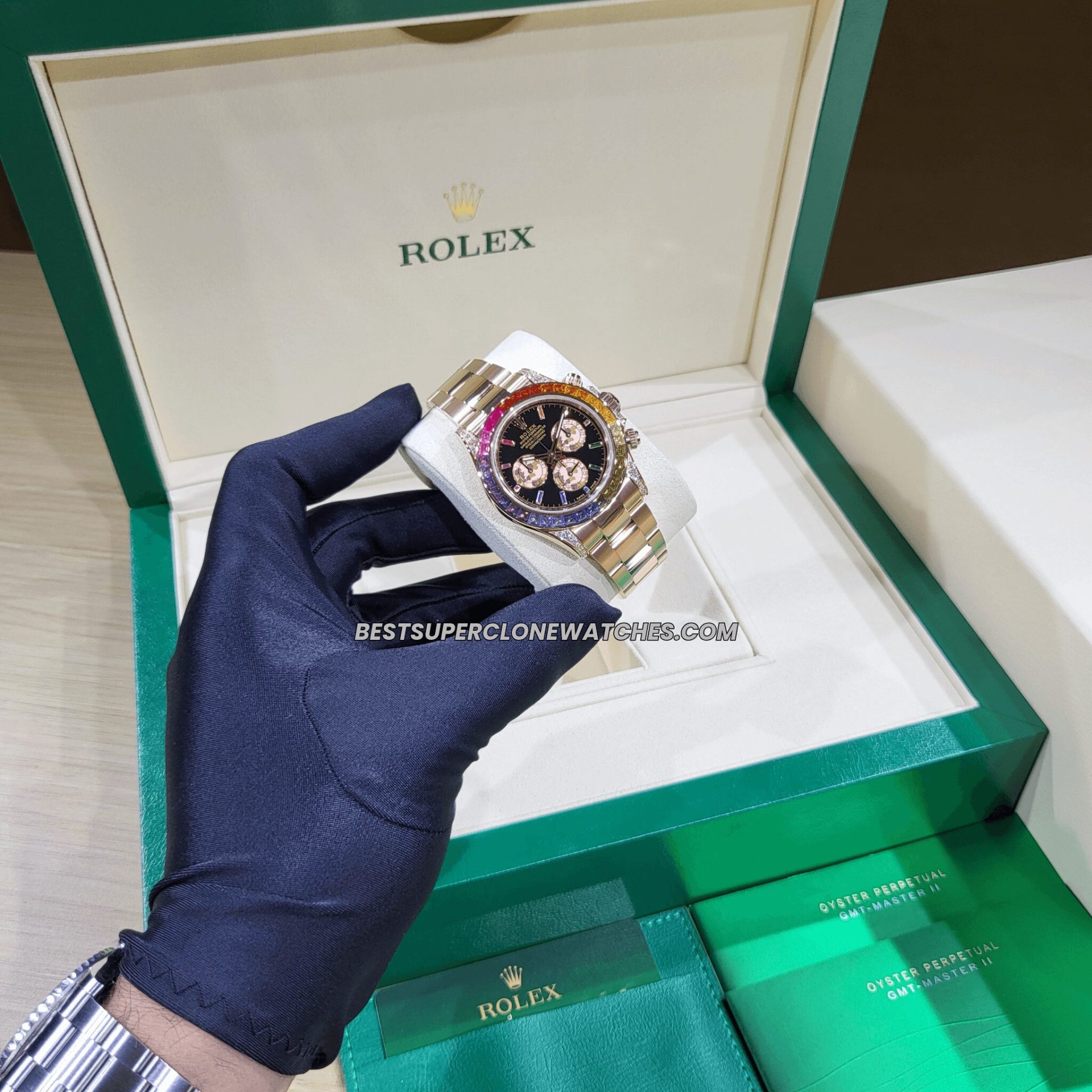 Luxury fake Rolex Daytona with diamond-set rainbow bezel and black dial on Everose gold case