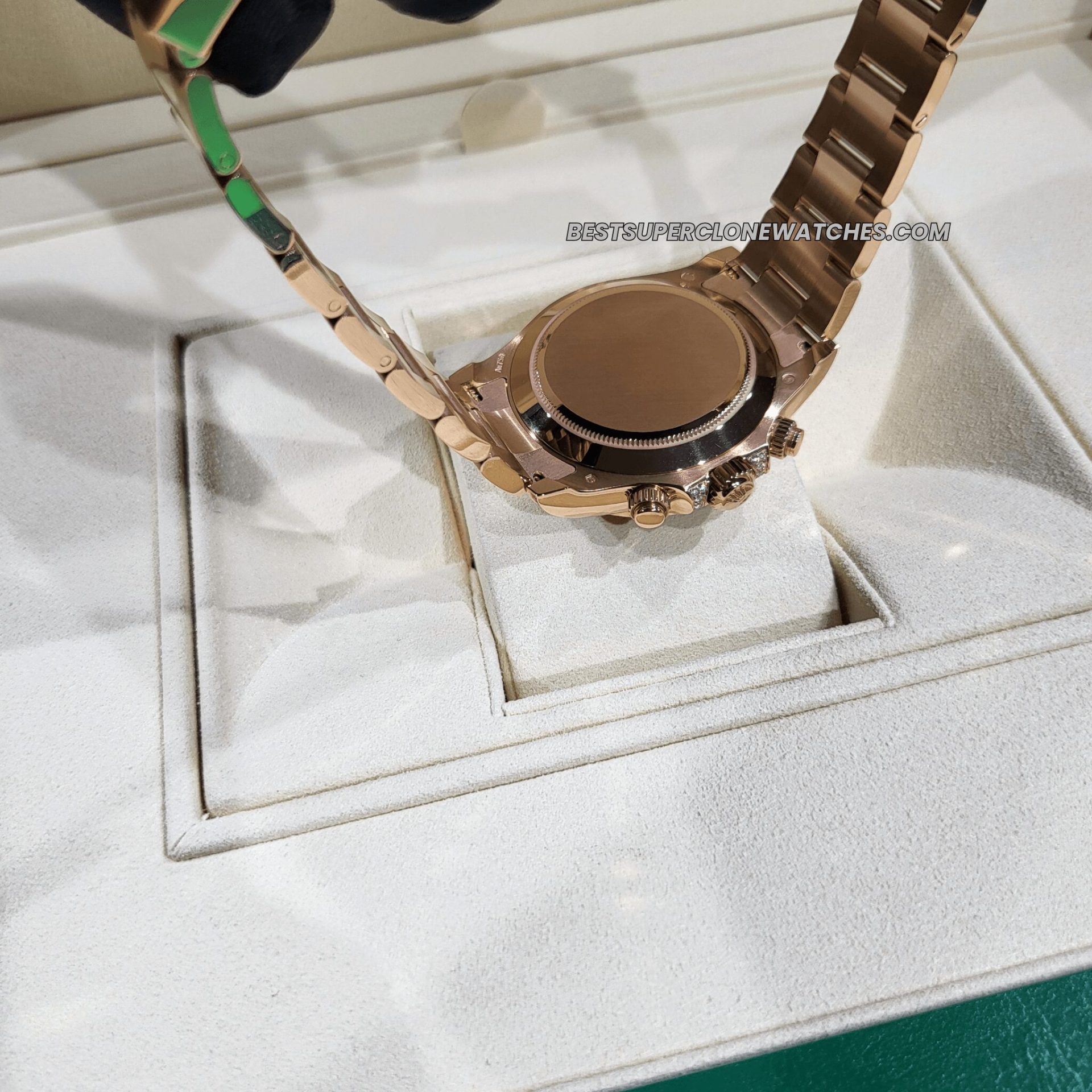 Close-up of Rolex Daytona super clone with black dial and multicolor gem-set rainbow bezel